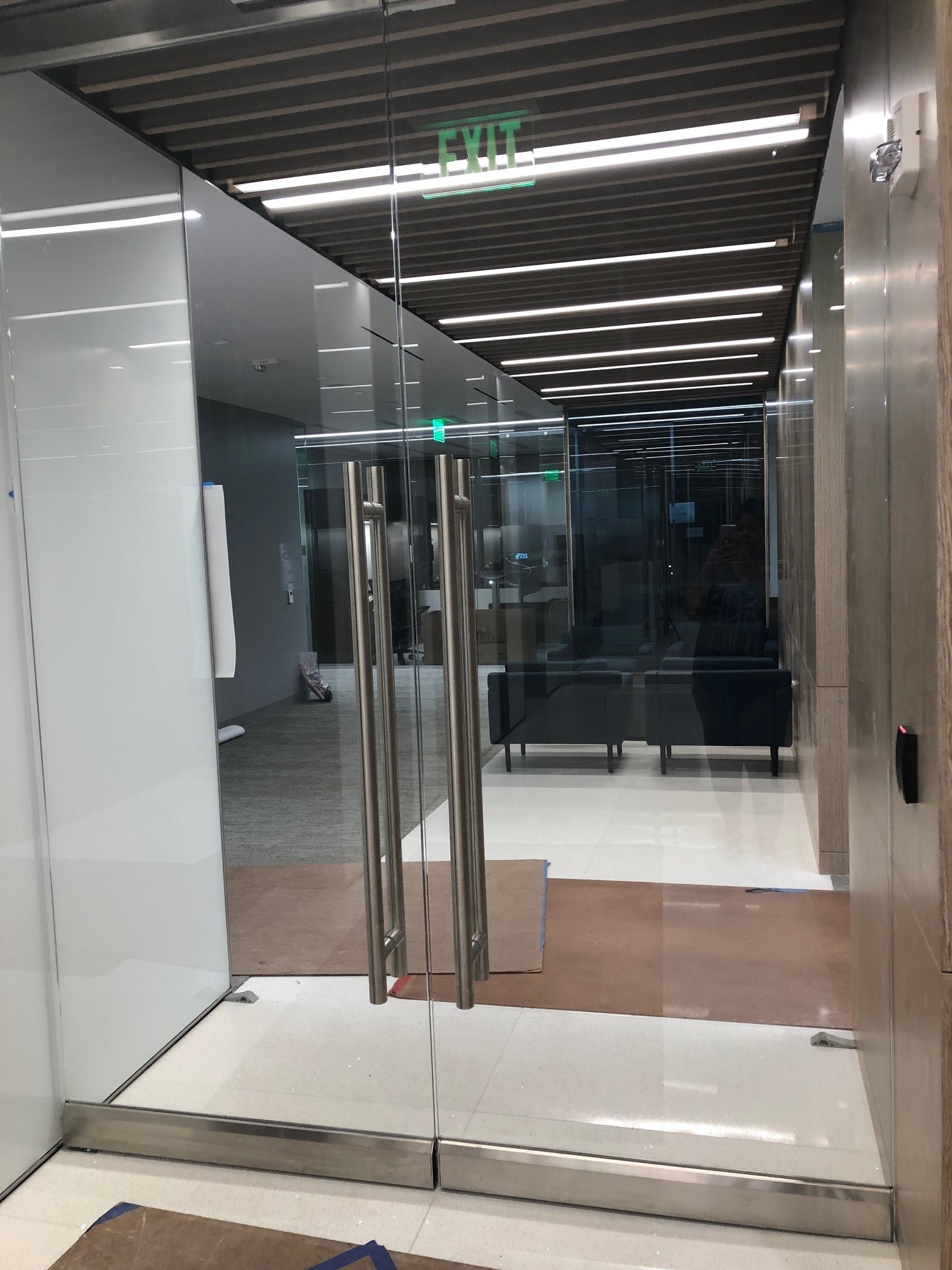 Interior glass doors with exit sign reflection
