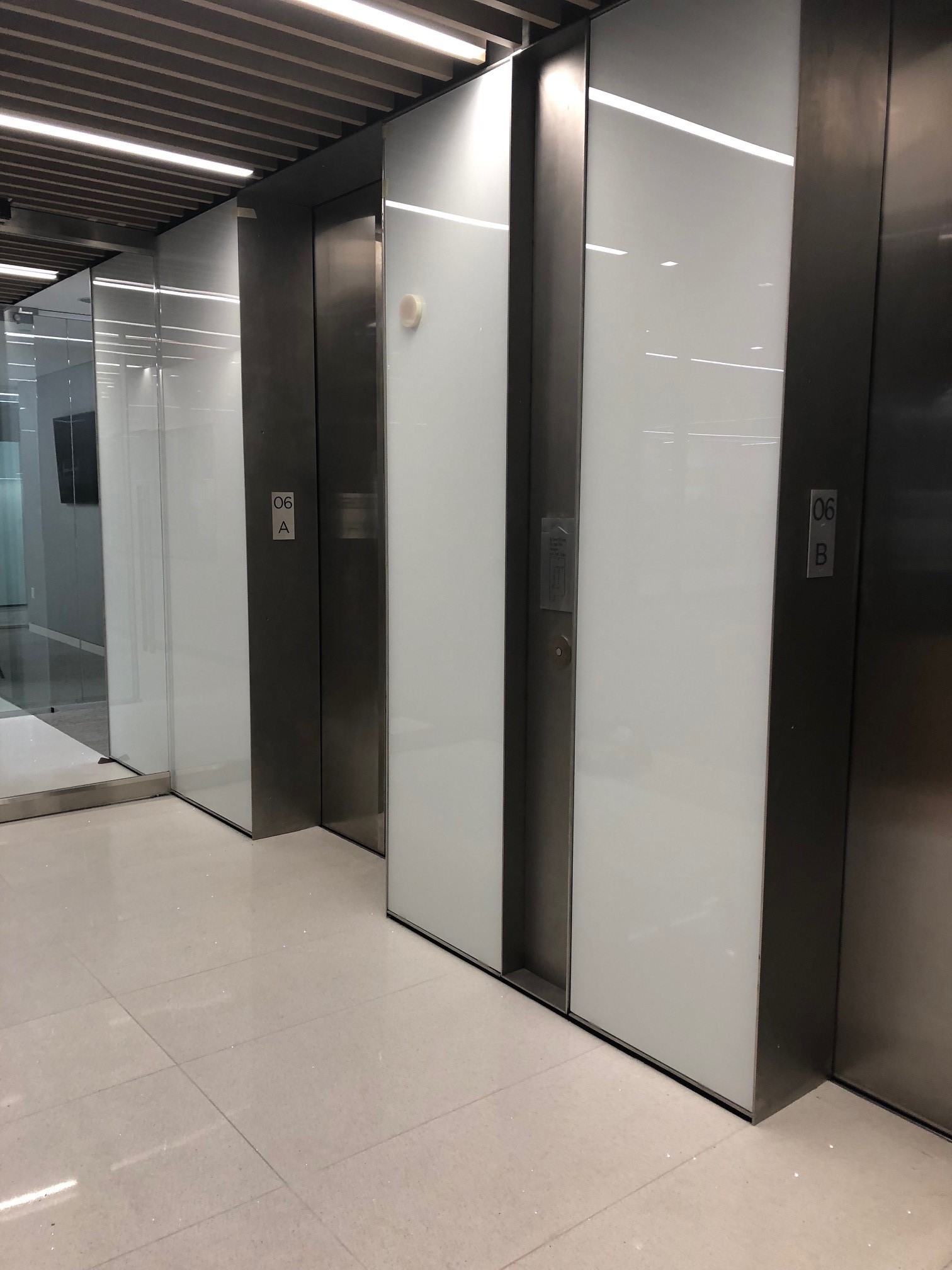 Frosted white glass elevator doors and panels