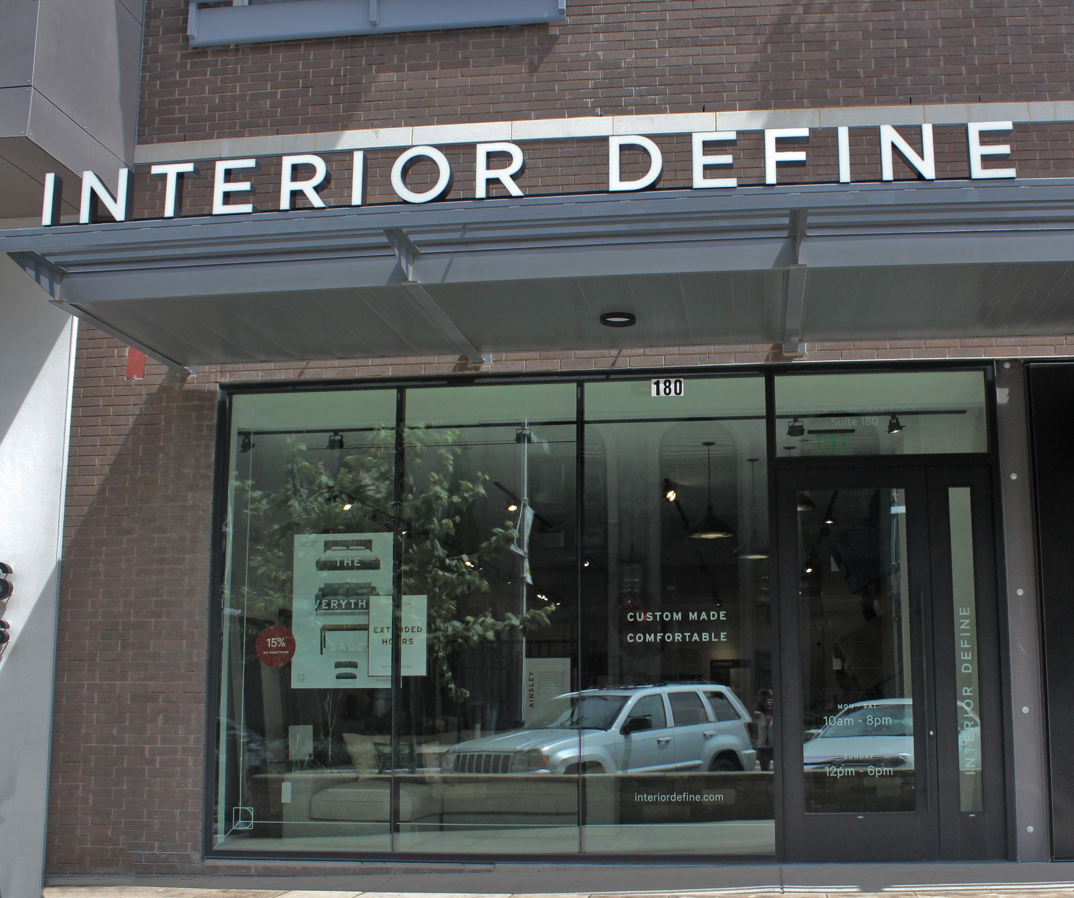 Storefront with glass windows and a sign showing 'Interior Defined'.