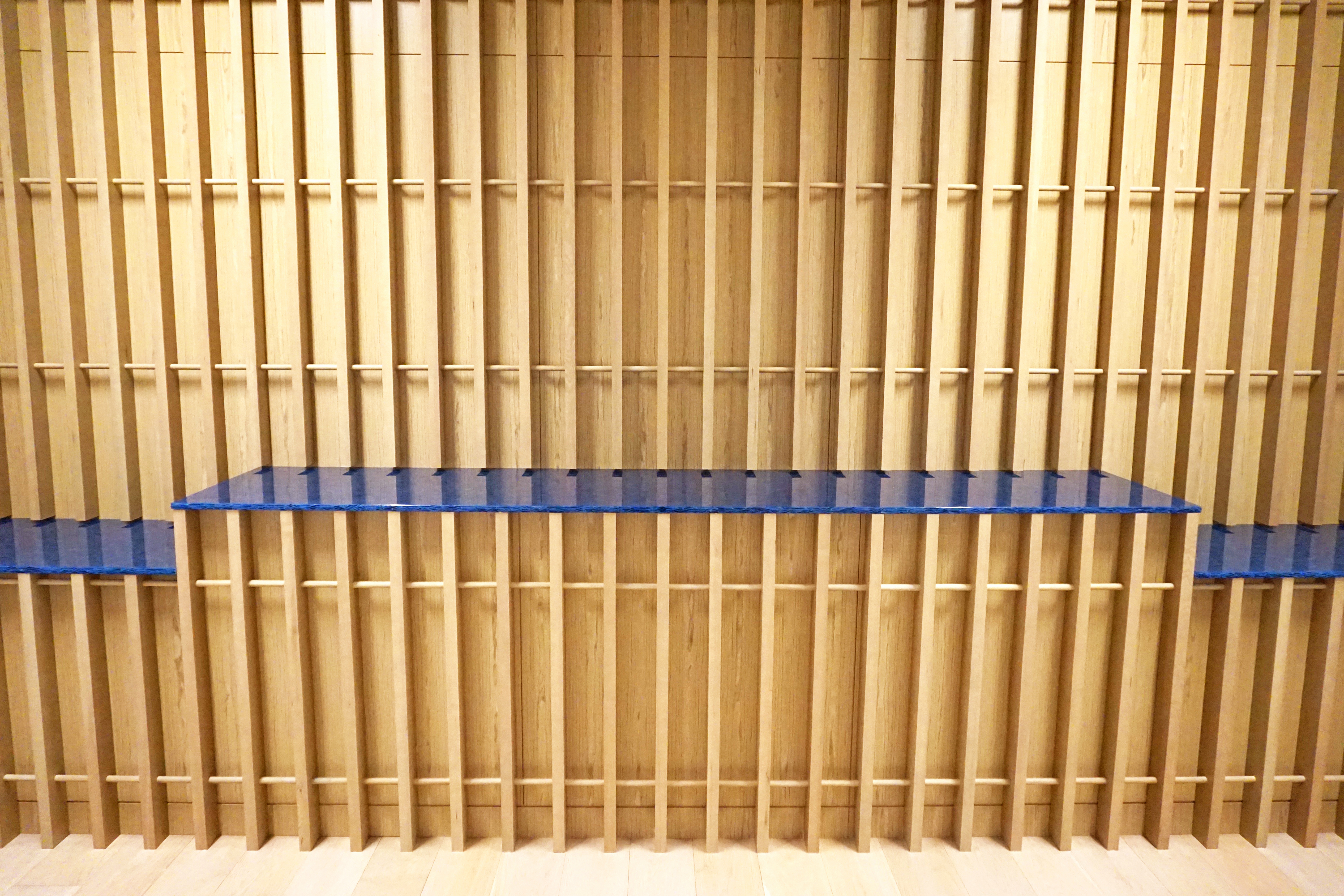 Bookshelves filled with neatly arranged books viewed from behind.