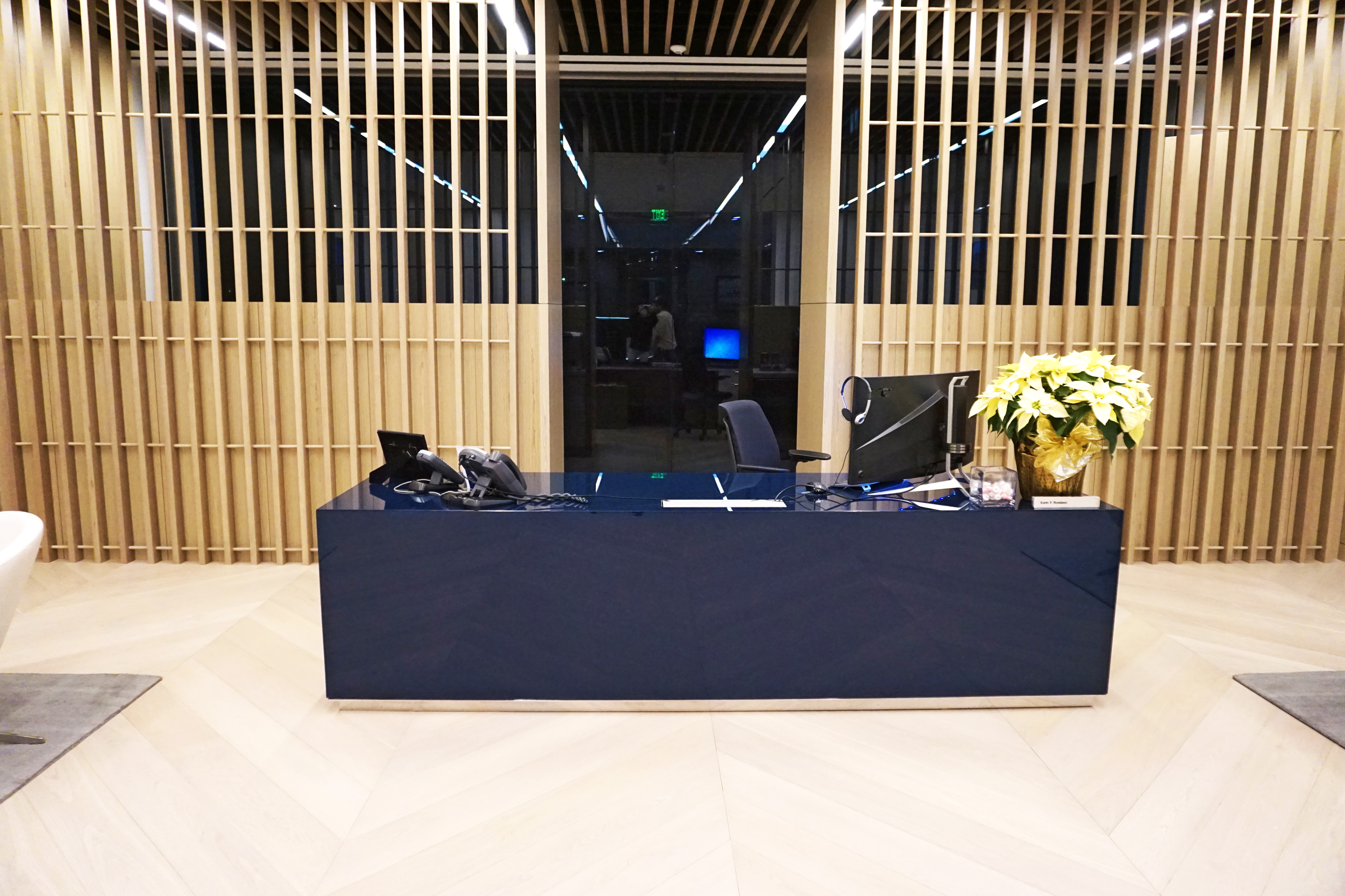 A reception desk with a computer and decorations in a modern interior.